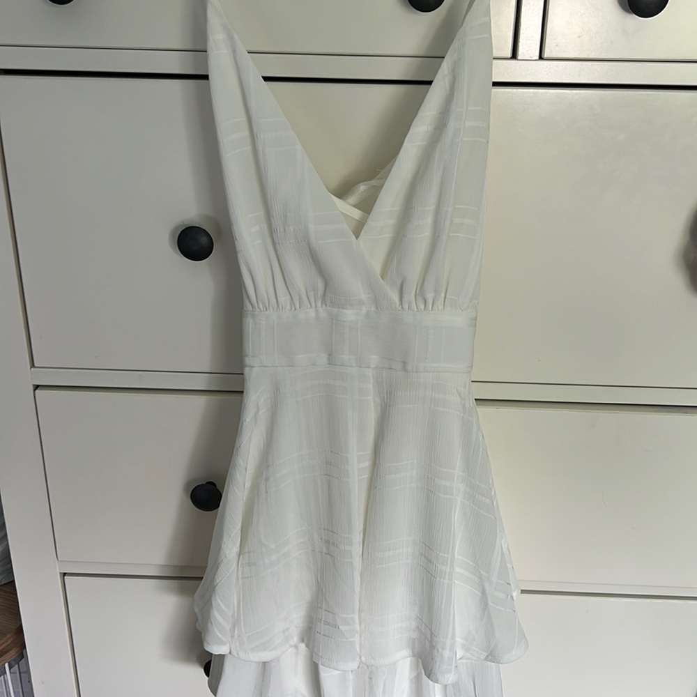 American threads white romper with tie in the back